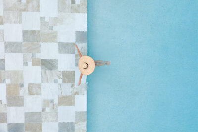 Woman sitting poolside