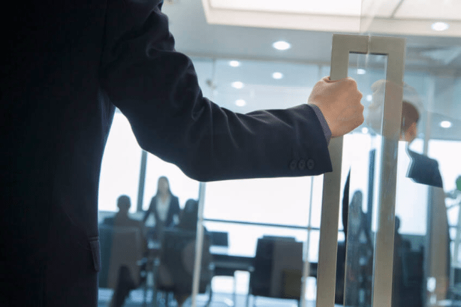 Businessman holding door open