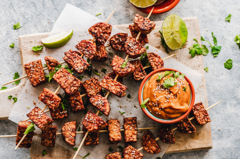 Sesame tempeh skewers with spicy peanut sauce.